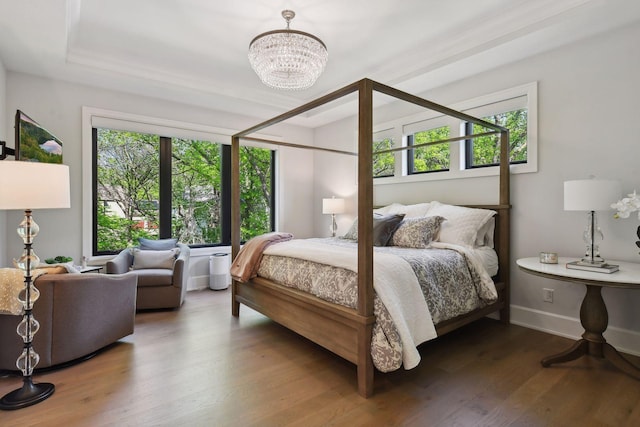 bedroom featuring a chandelier, dark wood-type flooring, and multiple windows