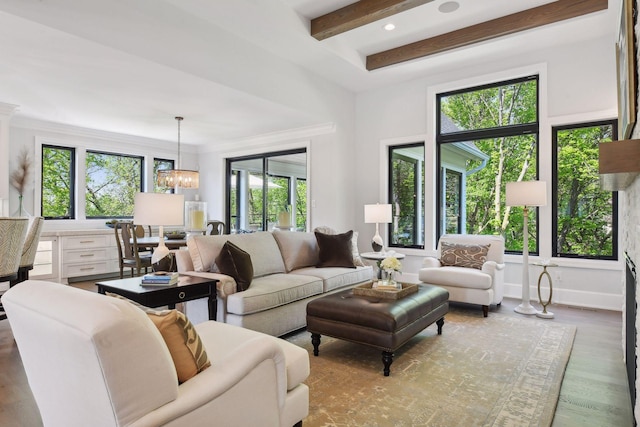 living room featuring light wood-type flooring, a chandelier, and beam ceiling