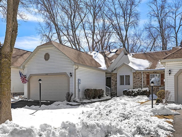 view of front of house featuring a garage and roof with shingles