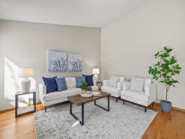 living area featuring baseboards and light wood-style floors