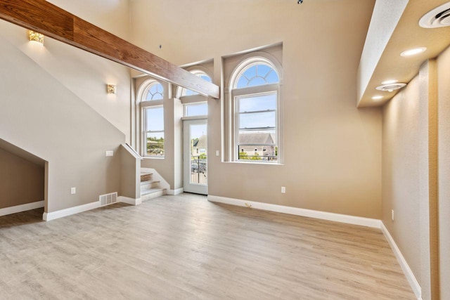 foyer entrance featuring a wealth of natural light and light hardwood / wood-style flooring