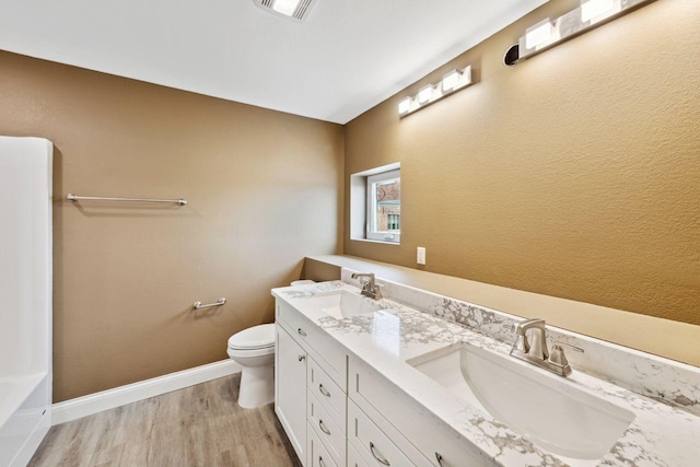 bathroom with hardwood / wood-style floors, toilet, and vanity