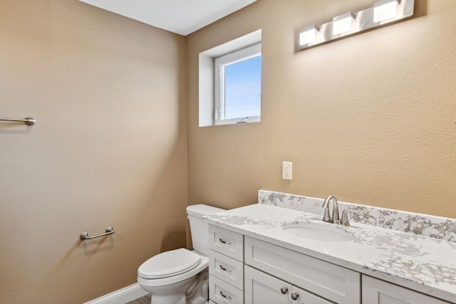 bathroom with toilet and vanity