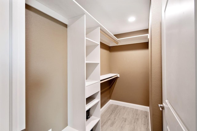 walk in closet featuring light hardwood / wood-style flooring