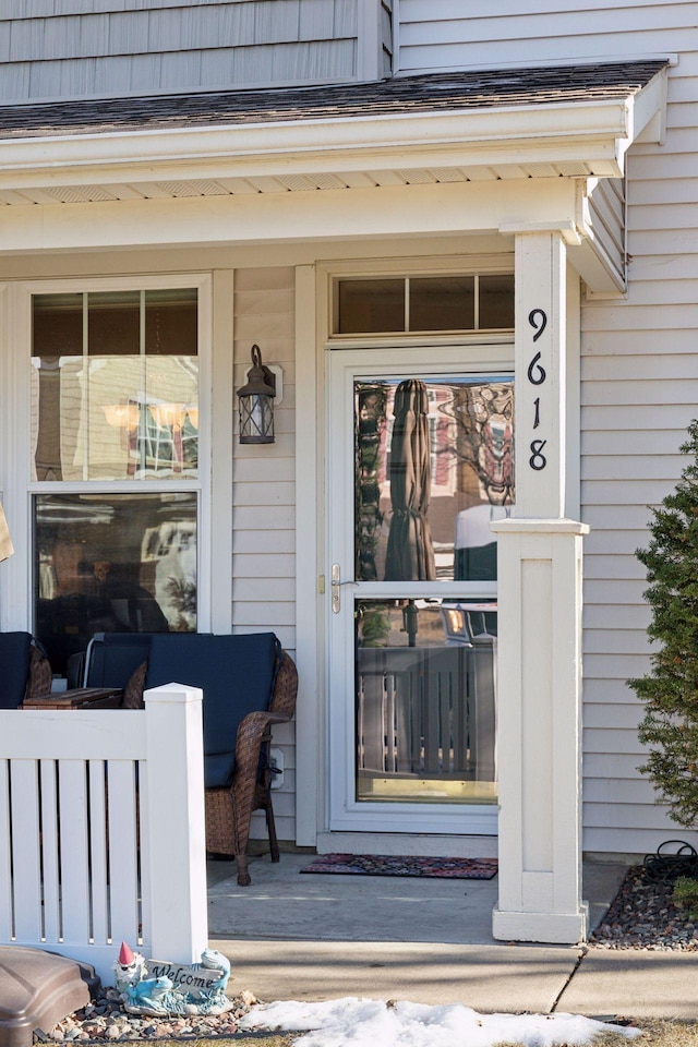 view of exterior entry with a porch