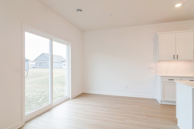 unfurnished dining area with light hardwood / wood-style flooring