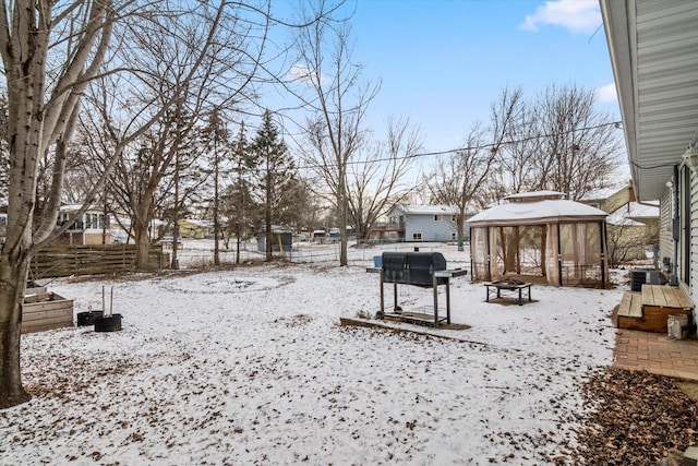 yard layered in snow featuring a gazebo and central AC