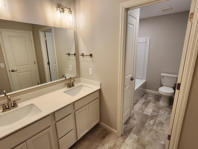 full bathroom with vanity, shower / bathtub combination, and toilet