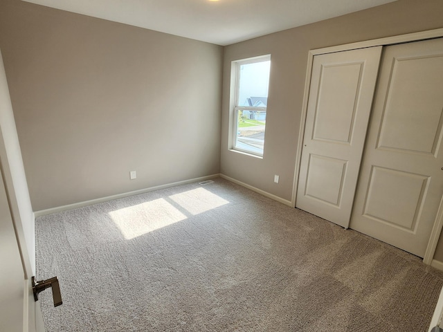 unfurnished bedroom featuring a closet and carpet flooring