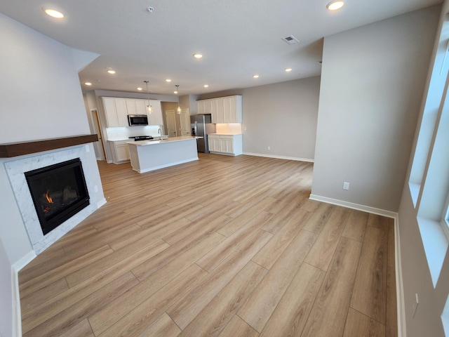 unfurnished living room with light wood-type flooring