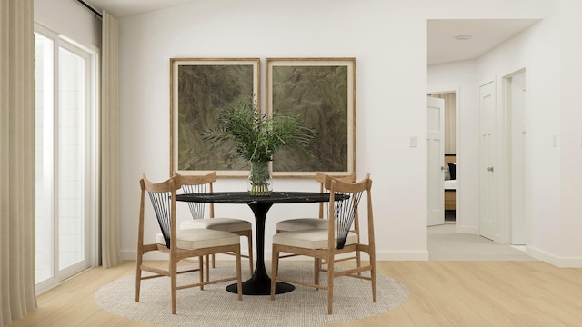 dining space featuring light wood-type flooring