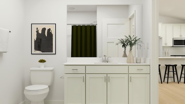 bathroom featuring hardwood / wood-style floors, backsplash, toilet, and vanity