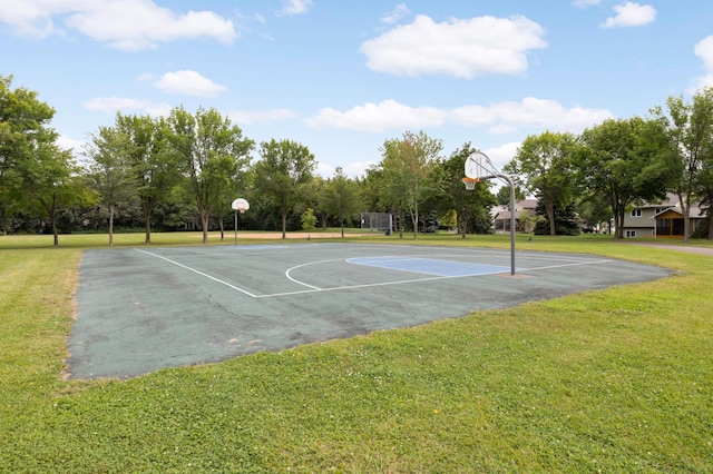 view of basketball court with a lawn