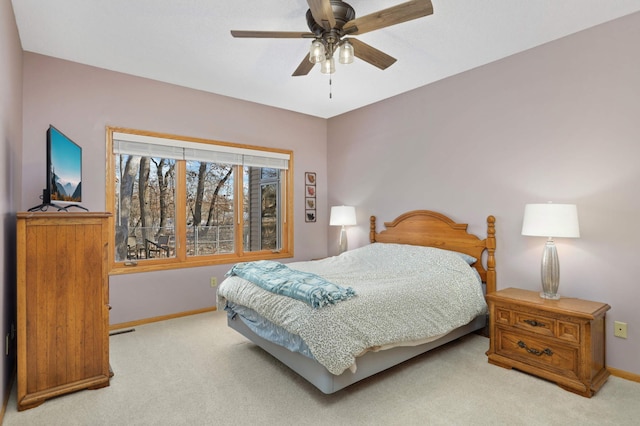 bedroom with ceiling fan and light carpet