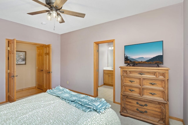 carpeted bedroom with ceiling fan and ensuite bathroom