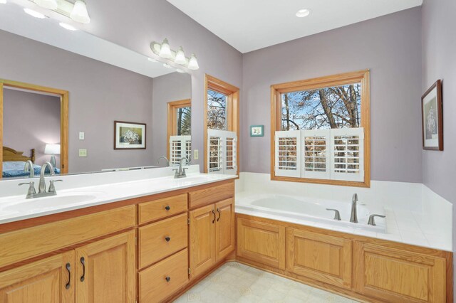 bathroom featuring vanity and a bath