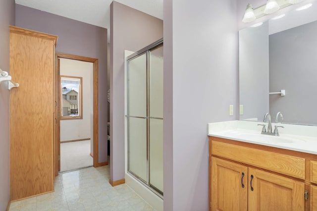 bathroom with vanity and a shower with shower door