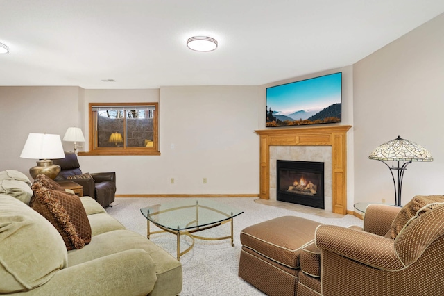 living room with light colored carpet and a tile fireplace