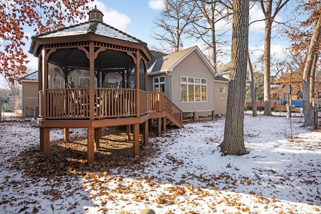 snow covered property with a gazebo and a deck