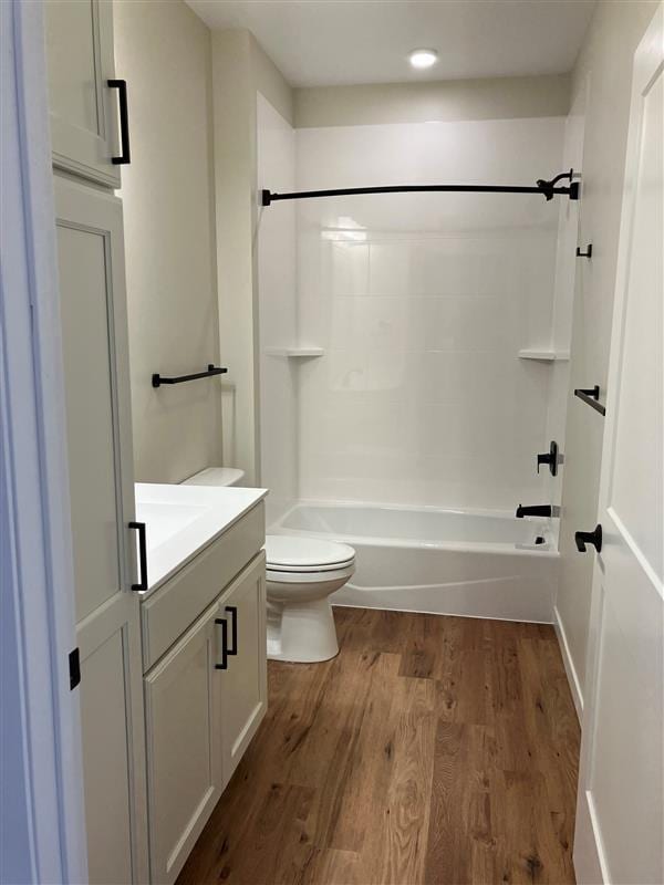 full bathroom featuring vanity, shower / washtub combination, hardwood / wood-style floors, and toilet