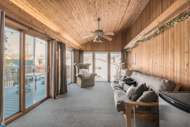 living room with carpet, wood walls, lofted ceiling, wooden ceiling, and a ceiling fan