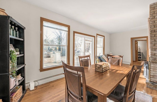 dining room with light wood-style floors and a baseboard radiator