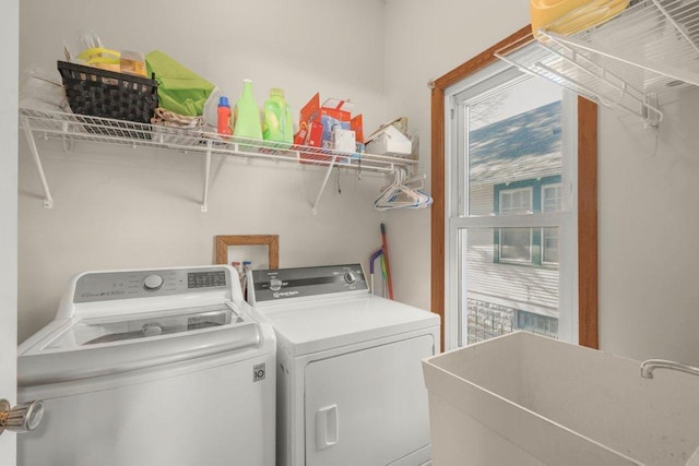 laundry area featuring a sink, washing machine and dryer, and laundry area