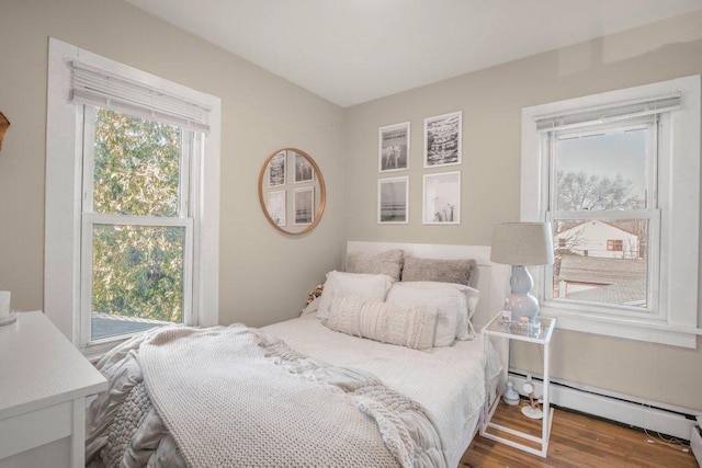 bedroom featuring a baseboard radiator and wood finished floors