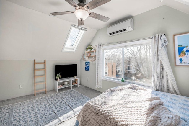 carpeted bedroom featuring a wall mounted air conditioner, lofted ceiling with skylight, and a ceiling fan