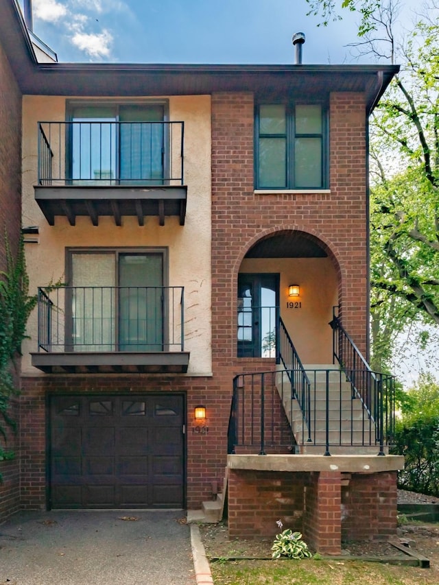 view of front of property featuring a garage and a balcony