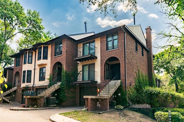 view of front facade featuring a balcony and central AC