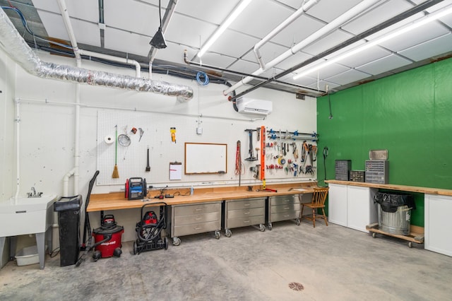 garage with a wall unit AC and a workshop area