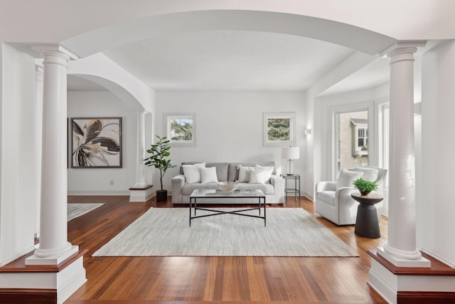 living room featuring hardwood / wood-style floors and ornate columns