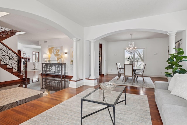 living room with dark wood-type flooring and decorative columns