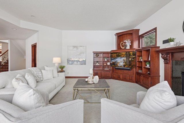 carpeted living room with a tile fireplace