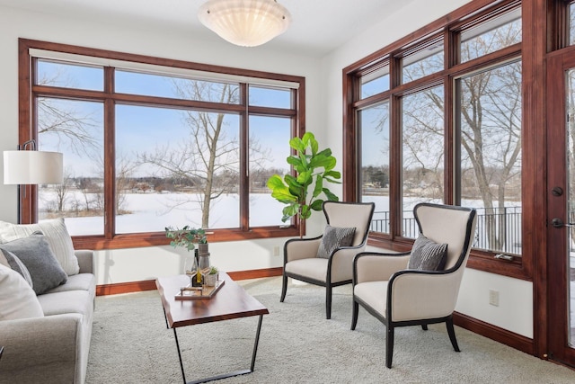 sunroom / solarium featuring a water view