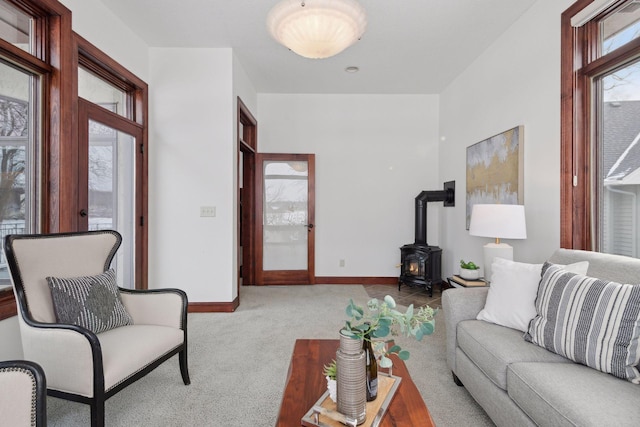 living room with light carpet and a wood stove