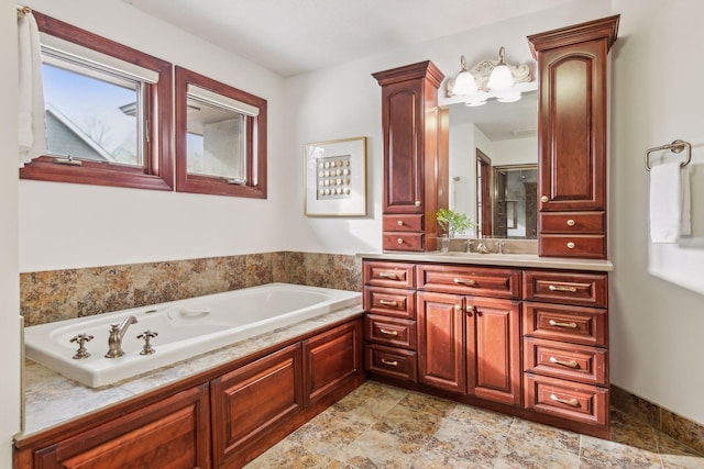 bathroom featuring vanity and a washtub