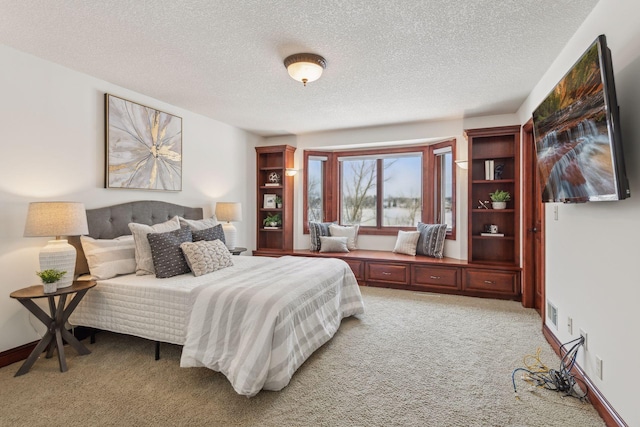 carpeted bedroom with a textured ceiling