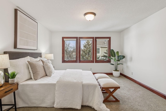 carpeted bedroom with a textured ceiling