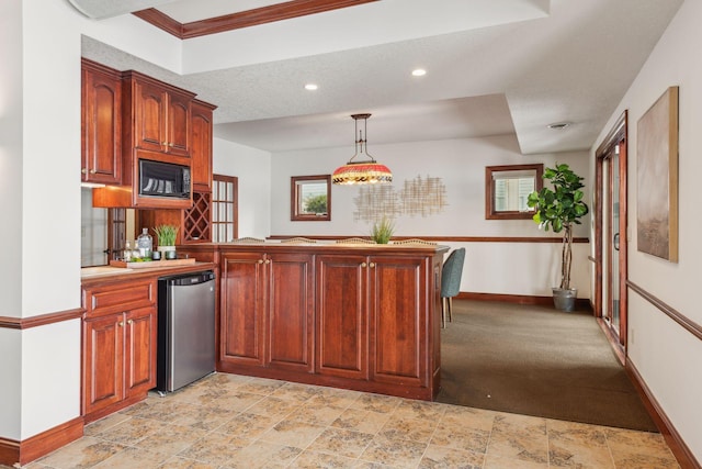 kitchen featuring pendant lighting, fridge, kitchen peninsula, and black microwave