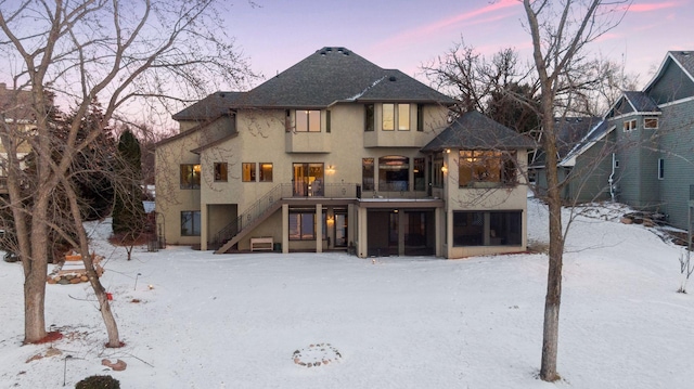 view of snow covered rear of property