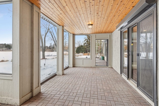 unfurnished sunroom with wooden ceiling