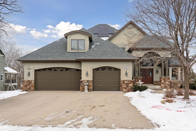 view of front facade with a garage and french doors