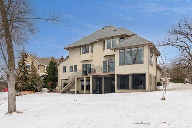 view of snow covered rear of property