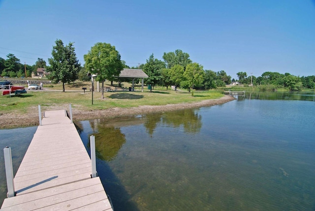 view of dock with a gazebo and a water view