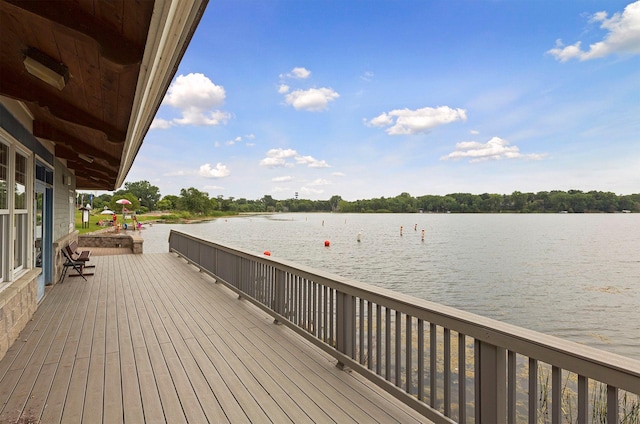 wooden deck featuring a water view