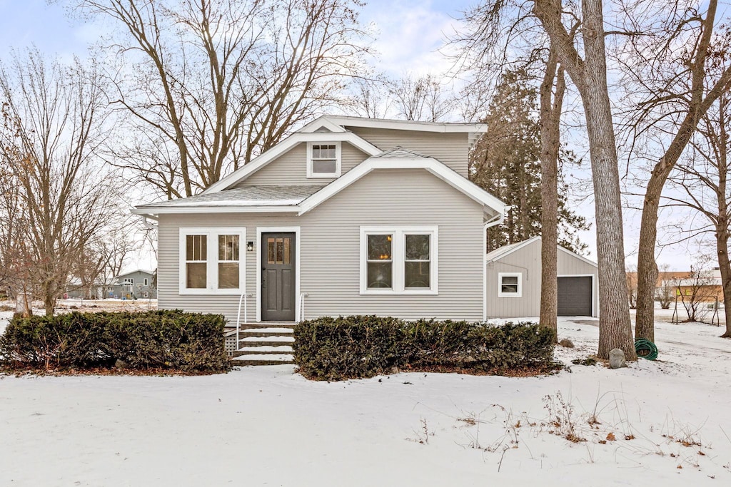 view of front of property featuring a garage and an outdoor structure