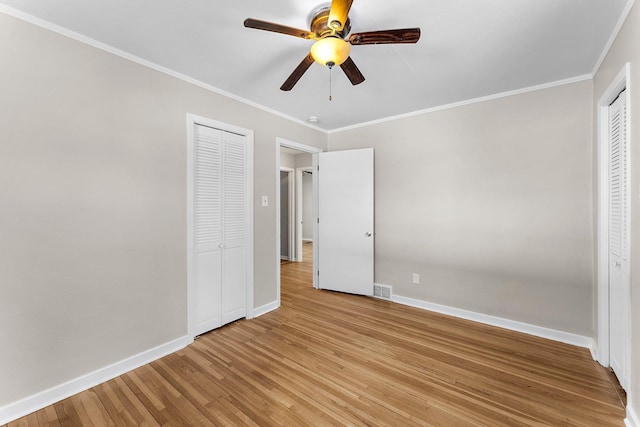 unfurnished bedroom featuring light hardwood / wood-style flooring, ornamental molding, and ceiling fan