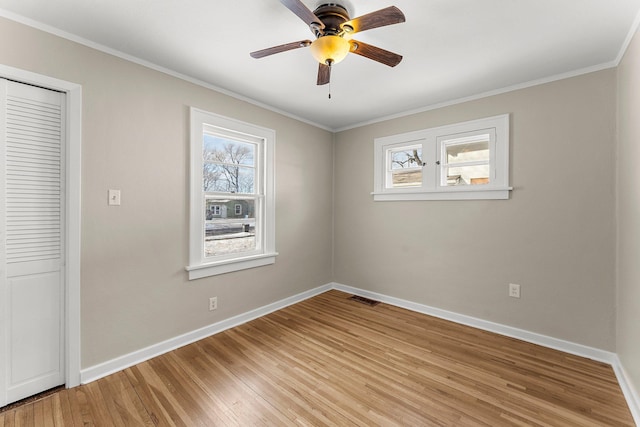 empty room featuring crown molding, ceiling fan, and light hardwood / wood-style flooring